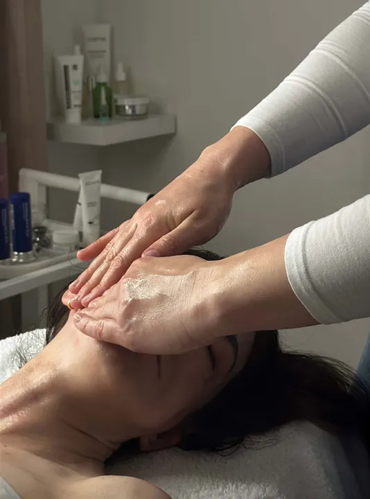 Skincare specialist performing a relaxing facial massage